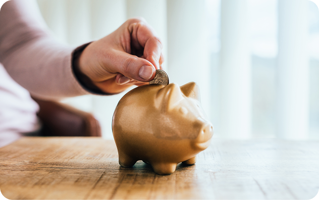 Saving money in golden piggy bank